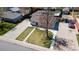 An aerial view of a home with a long driveway, a well-maintained lawn and mature shade tree at 7621 Granada Rd, Denver, CO 80221