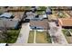 Aerial view of a single-Gathering home equipped with solar panels, a fenced yard, shed and detached garage at 7621 Granada Rd, Denver, CO 80221