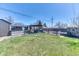 Backyard features a gravel area, pergola, shed, and grassy area perfect for outdoor enjoyment at 7621 Granada Rd, Denver, CO 80221