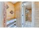 Cozy bathroom with a wood paneled accent wall and natural light at 7621 Granada Rd, Denver, CO 80221