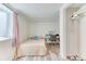 Bright bedroom with light wood floors, vanity desk and a closet at 7621 Granada Rd, Denver, CO 80221