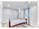 Small bedroom features a single bed, wood floor, and a window at 7621 Granada Rd, Denver, CO 80221