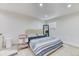 Cozy bedroom with carpeted floors, a stylish bed frame, and neutral decor at 7621 Granada Rd, Denver, CO 80221
