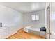 Bright bedroom with hardwood floors, minimalist decor, and a clean, modern aesthetic at 7621 Granada Rd, Denver, CO 80221
