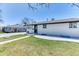 Charming single story home features a well-manicured lawn and a classic white brick exterior at 7621 Granada Rd, Denver, CO 80221