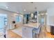 Bright, stylish kitchen with a spacious island, stainless appliances, and a mix of tile and wood floors at 7621 Granada Rd, Denver, CO 80221