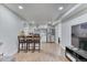 Modern kitchen featuring barstool seating, stainless steel appliances and white cabinetry at 7621 Granada Rd, Denver, CO 80221