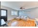 Comfortable living room with a sectional sofa, hardwood floors, and stylish decor at 7621 Granada Rd, Denver, CO 80221