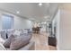 Open-concept living space with modern furnishings and a kitchen with bar seating at 7621 Granada Rd, Denver, CO 80221