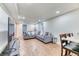 Basement living room with recessed lights, a sectional couch, and a TV at 7621 Granada Rd, Denver, CO 80221