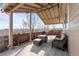 This covered back patio boasts beautiful views, a built-in grill, and a cozy seating area at 3230 S Decatur St, Denver, CO 80236
