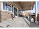 Relax on this covered patio with an outdoor kitchen, sliding glass doors, and comfortable seating at 3230 S Decatur St, Denver, CO 80236