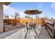 This patio includes a BBQ area, dining area, and privacy fence surrounding the outdoor space at 3230 S Decatur St, Denver, CO 80236