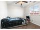 A standard bedroom with simple finishes features a bed, ceiling fan, and view from the window at 3230 S Decatur St, Denver, CO 80236