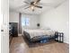 A spacious bedroom features modern finishes, natural light from the window, and room to relax at 3230 S Decatur St, Denver, CO 80236