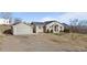 Charming single-Gathering home featuring a detached garage and a spacious front yard at 3230 S Decatur St, Denver, CO 80236