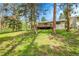 View of back deck with railings, home with light siding, and green lawn at 26752 Vosler St, Conifer, CO 80433