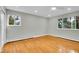 Bedroom with dual windows, hardwood floors, and closet doors at 26752 Vosler St, Conifer, CO 80433