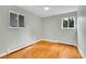 Bright bedroom featuring hardwood floors, and natural light through the two windows at 26752 Vosler St, Conifer, CO 80433