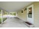 Attached carport and front door of home with neutral siding and a concrete slab at 26752 Vosler St, Conifer, CO 80433