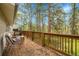 Inviting deck with wood railing, seating, and serene views of surrounding trees and nature at 26752 Vosler St, Conifer, CO 80433