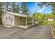 Wide angle view of home featuring a carport, metal roof, neutral siding, and asphalt driveway at 26752 Vosler St, Conifer, CO 80433