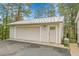 View of detached one car garage with beige siding and metal roof at 26752 Vosler St, Conifer, CO 80433