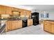 Well-lit kitchen boasts wood cabinets, black appliances and a brick backsplash at 26752 Vosler St, Conifer, CO 80433