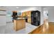 Bright kitchen featuring wood cabinets, granite island, black appliances and tile flooring at 26752 Vosler St, Conifer, CO 80433