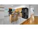Well-lit kitchen with wood cabinets, granite island and black appliances at 26752 Vosler St, Conifer, CO 80433
