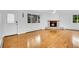 Living room with a cozy stone fireplace, hardwood floors, and view to the greenery at 26752 Vosler St, Conifer, CO 80433