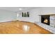Living room featuring stone fireplace, hardwood floors, and large window at 26752 Vosler St, Conifer, CO 80433