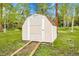 Exterior view of a storage shed with beige siding and a front door at 26752 Vosler St, Conifer, CO 80433