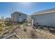 Landscaped backyard with patio area, hammock, drought resistant ground cover, and grassy area at 12881 Park Creek Way, Firestone, CO 80504
