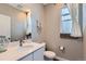 Charming powder room featuring modern fixtures, vanity, and a window with lots of natural light at 12881 Park Creek Way, Firestone, CO 80504