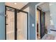 Elegant bathroom featuring a tiled shower with modern fixtures and a view to the bedroom at 12881 Park Creek Way, Firestone, CO 80504