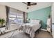 Inviting bedroom with a large window, ceiling fan, and modern decor create a comfortable space at 12881 Park Creek Way, Firestone, CO 80504