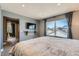 Large window provides ample natural light in this spacious bedroom featuring modern finishes at 12881 Park Creek Way, Firestone, CO 80504