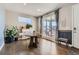 Charming dining room with hardwood floors, a round table, and natural light from the sliding glass door at 12881 Park Creek Way, Firestone, CO 80504