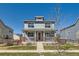 Charming two-story home with a welcoming front porch and well-maintained lawn under a clear blue sky at 12881 Park Creek Way, Firestone, CO 80504