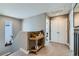 Hallway features a decorative table with plants, neutral paint, carpet, and white doors with black hardware at 12881 Park Creek Way, Firestone, CO 80504