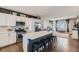Bright kitchen features stainless appliances, a spacious island with seating, and modern finishes that elevate the space at 12881 Park Creek Way, Firestone, CO 80504