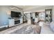 Open-concept living area with hardwood floors, a fireplace, and seamless flow to the kitchen at 12881 Park Creek Way, Firestone, CO 80504