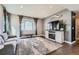 Comfortable living room featuring hardwood floors, ample natural light, and contemporary furnishings at 12881 Park Creek Way, Firestone, CO 80504