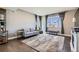 Bright and airy living room with hardwood floors, neutral decor, and a cozy seating arrangement at 12881 Park Creek Way, Firestone, CO 80504