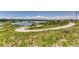 Scenic walking path winding through lush greenery with a lake view at 12881 Park Creek Way, Firestone, CO 80504