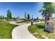 A picturesque Waterside Park with lush greenery, walking paths, and playground at 12881 Park Creek Way, Firestone, CO 80504