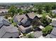 Aerial view of a home with solar panels, a detached garage, and mature trees at 1362 Golden Eagle Way, Louisville, CO 80027