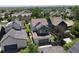 Aerial view of a home with solar panels and a detached garage, surrounded by lush greenery at 1362 Golden Eagle Way, Louisville, CO 80027