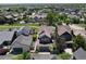 Aerial view of a neighborhood with houses that have solar panels, green spaces, and nearby trails at 1362 Golden Eagle Way, Louisville, CO 80027